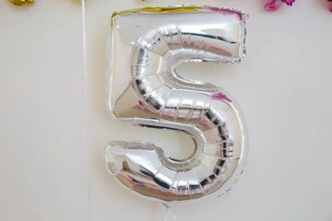 One of full number set .Chrome number 5 made of inflatable balloon isolated o Stock Photos