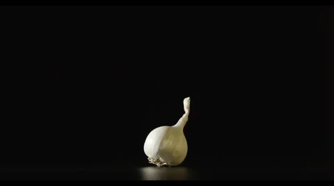 One garlic lies on a table - Light is ON and OFF Stock Footage 62196989