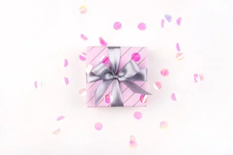 One gift boxe with bow and confetti on a white background. Foto stock