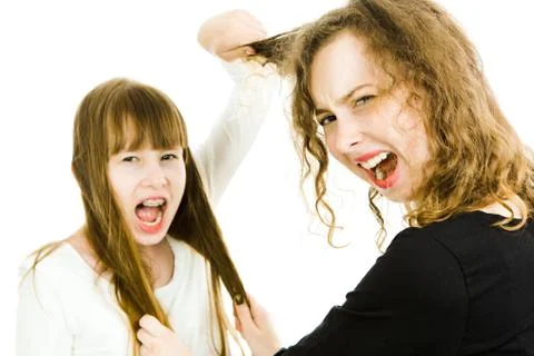 One girl abusing other by pulling her hairs - rivalry. Foto stock