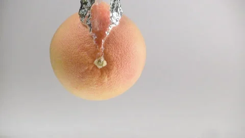 One grapefruit fall into the water with splashes and bubbles in slow motion Stock-Footage 144444925