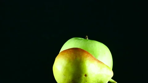 One green apple and one pear rotating Stock Footage 167599250