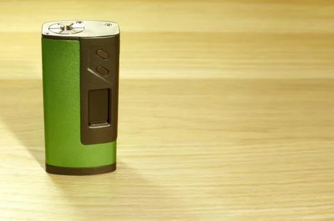One green boxmod device for vaping (electronic cigarette) on the wooden sur.. Stock Photos