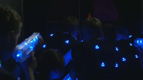 One group of children hide from another group of children plaing lasertag Stock Footage 77357526