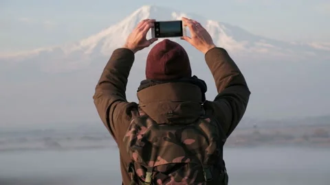 One guy with smartphone making a photography of beautiful natural scene of natio Stock Footage 201097311