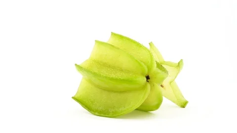One half and one slice of ripe carambola fruit. Rotating on the turntable Stock Footage 95465543