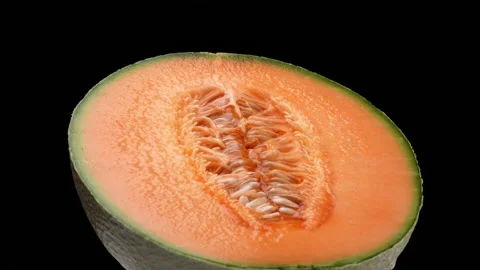 One half of a cantaloupe melon is rotating. Isolated on black background. Stock Footage 169842639