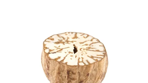 One half cut peeled nutmeg. Quickly rotating on the turntable isolated  Stock Footage 95856911