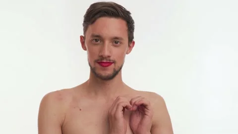 One half naked man with beard wear red lipstick on lips, makes heart gesture Stock Footage 147575003