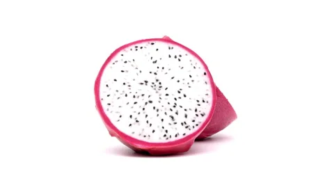 One half of pink dragon fruit is rotating on white background. Stock Footage 158916561