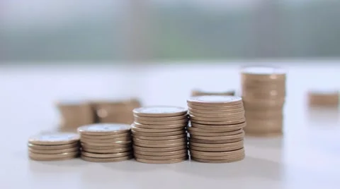 One hand dragging a pile of coins on the table Stock-Footage 58509526