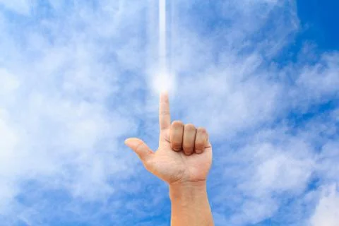 One hand  pointed in to the clear blue sky Stock Photos