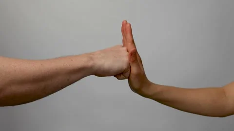 One hand preventing punch attack of another hand Stock Footage 238355235