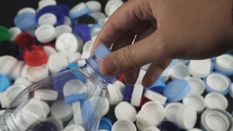 One hand removes the plastic cap from a bottle. Stock Footage 124644697