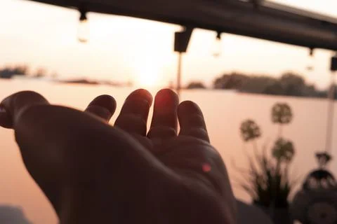 One hand on sunset Stock Photos