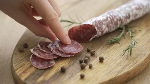 One hand takes the knife and slices of slices to savor the quality. Concept of Stock Footage 148900448