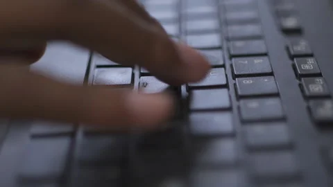One Hand Typing Shallow Focus On Black Computer Keyboard Video stock 150598433