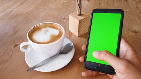 One hand using a smart phone with green screen on display Stock Footage 103465796