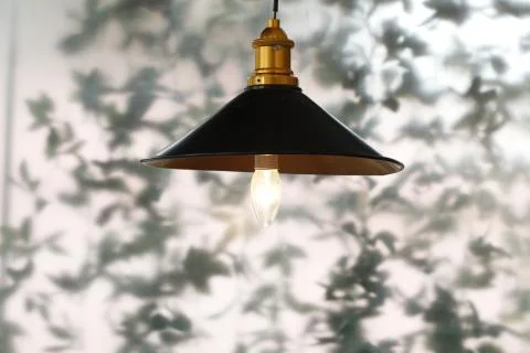 One hanging lamp with window in the background Stock Photos