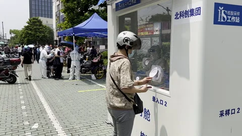 One has to bend down and bow head to get coronavirus PCR test Video stock 243417397