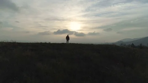 One hike man walking on the hill to lake at sunset Stock Footage 83578296
