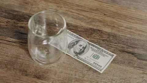One Hundred Dollar Banknote and Empty Glass on Wooden Table, Personal Finance Video stock 340857224