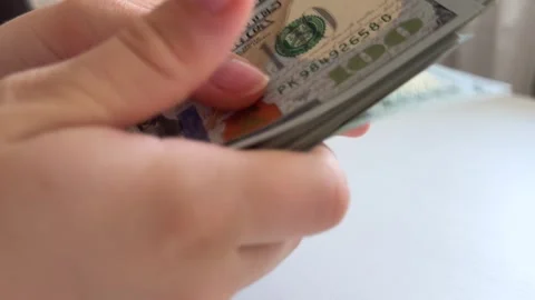 One hundred dollar bills counted, displayed and arranged on white background Stock Footage 345173233