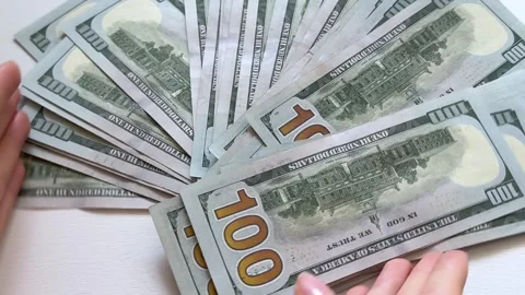 One hundred dollar bills counted, displayed and arranged on white background Stock Footage 345177101