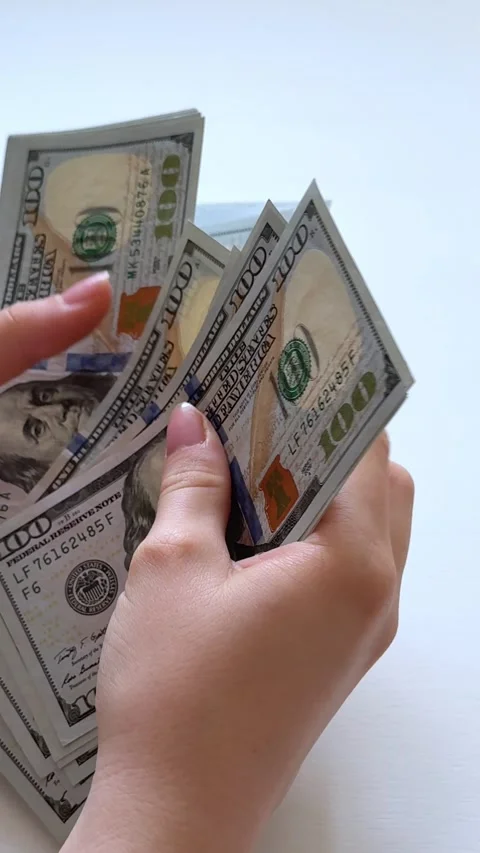 One hundred dollar bills counted by female hands before paying apartment rent Stock Footage 345179876