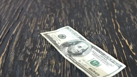 One hundred dollar bills falling on the table. Stock Footage 88657316