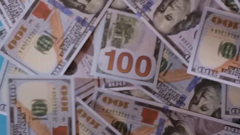One hundred dollar bills falling onto a blue surface Stock-Footage 331460944