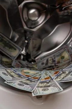 One hundred dollar bills inside open washing machine drum closeup Fotos Stock