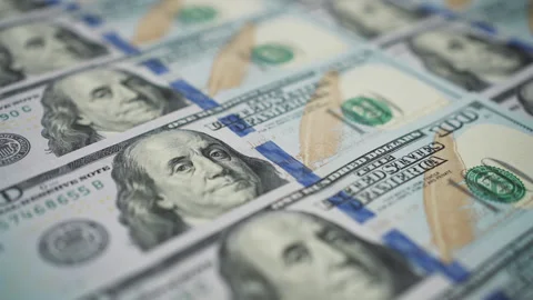 One hundred dollar bills moving downwards vertically on table surface 動画素材 334876958