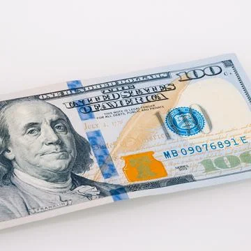 One hundred dollar cash bill on a light background. Stock Photos