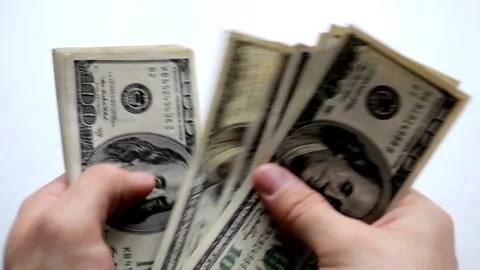 One hundred dollars banknotes pack in hands. Male hands counting dollar cash in Stock-Footage 336262941