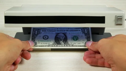One hundred dollars in the detector look like a one-dollar bill Stock Footage 79034926