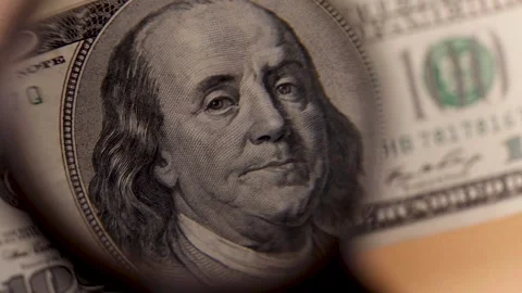 One hundred dollars inspecting under magnifying glass, loupe. Counterfeit money Stock Footage 227358589