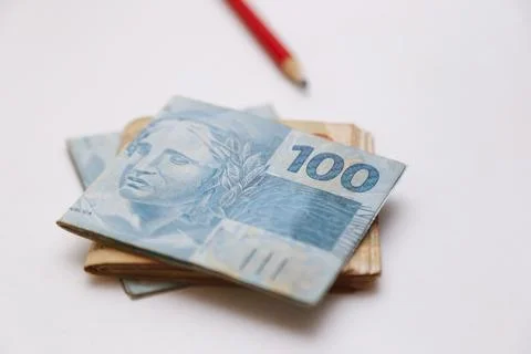 One hundred real notes and other notes on the table with pencil Foto stock