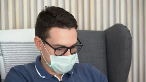 One illness guy wear protective mask, earphones, listen to music, relax, enjoy. Stock Footage 131476508