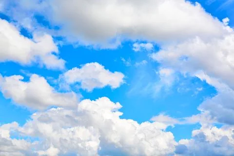 One isolated white cloud in a blue sky. Heaven background. Wallpaper. Beautif Stock Photos