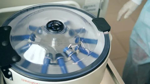 One laboratory worker uses machine while checking samples. Video stock 120524084