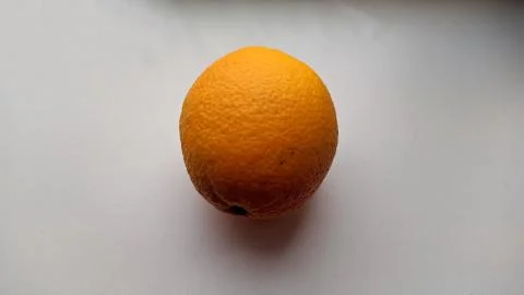 One large orange on a white background closeup photo Stock-Fotos