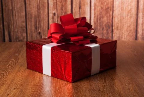 One large red gift box on a wood Stock Photos