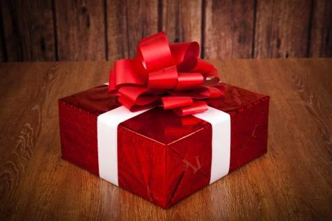 One large red gift box on a wood Stock Photos
