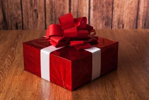 One large red gift box on a wood Stock Photos