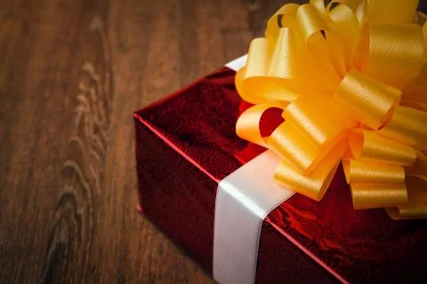 One large red gift box on a wood Stock Photos