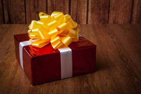One large red gift box on a wood Stock Photos