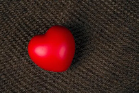 One large red heart on a textile background Stock Photos