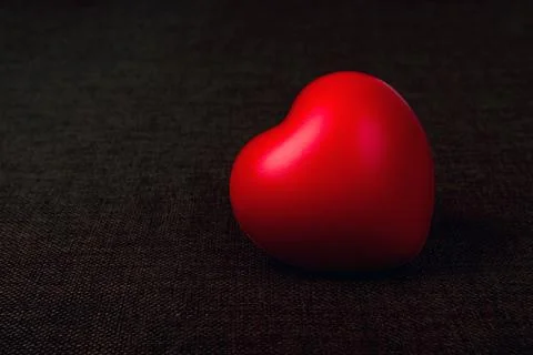 One large red heart on a textile background Stock Photos