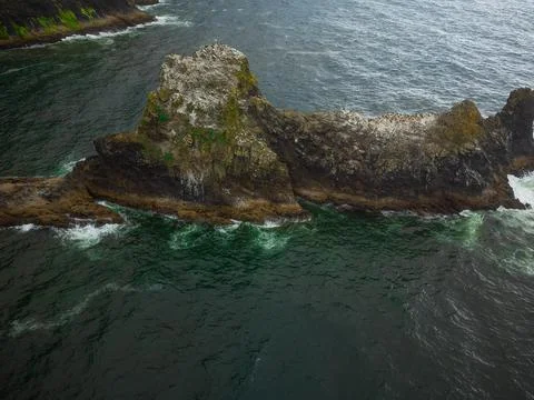 One large, stone, bizarre boulder in the ocean. There are no people in the ph Stock Photos